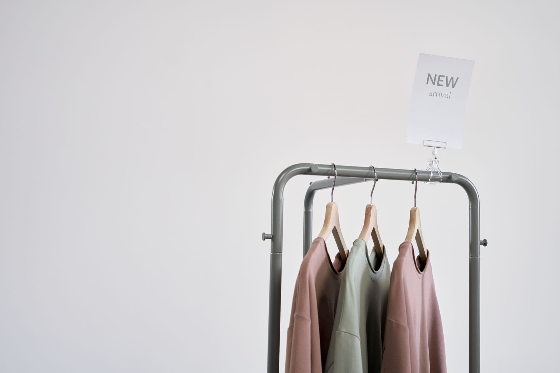 A dress on a hanger against a neutral wall.
