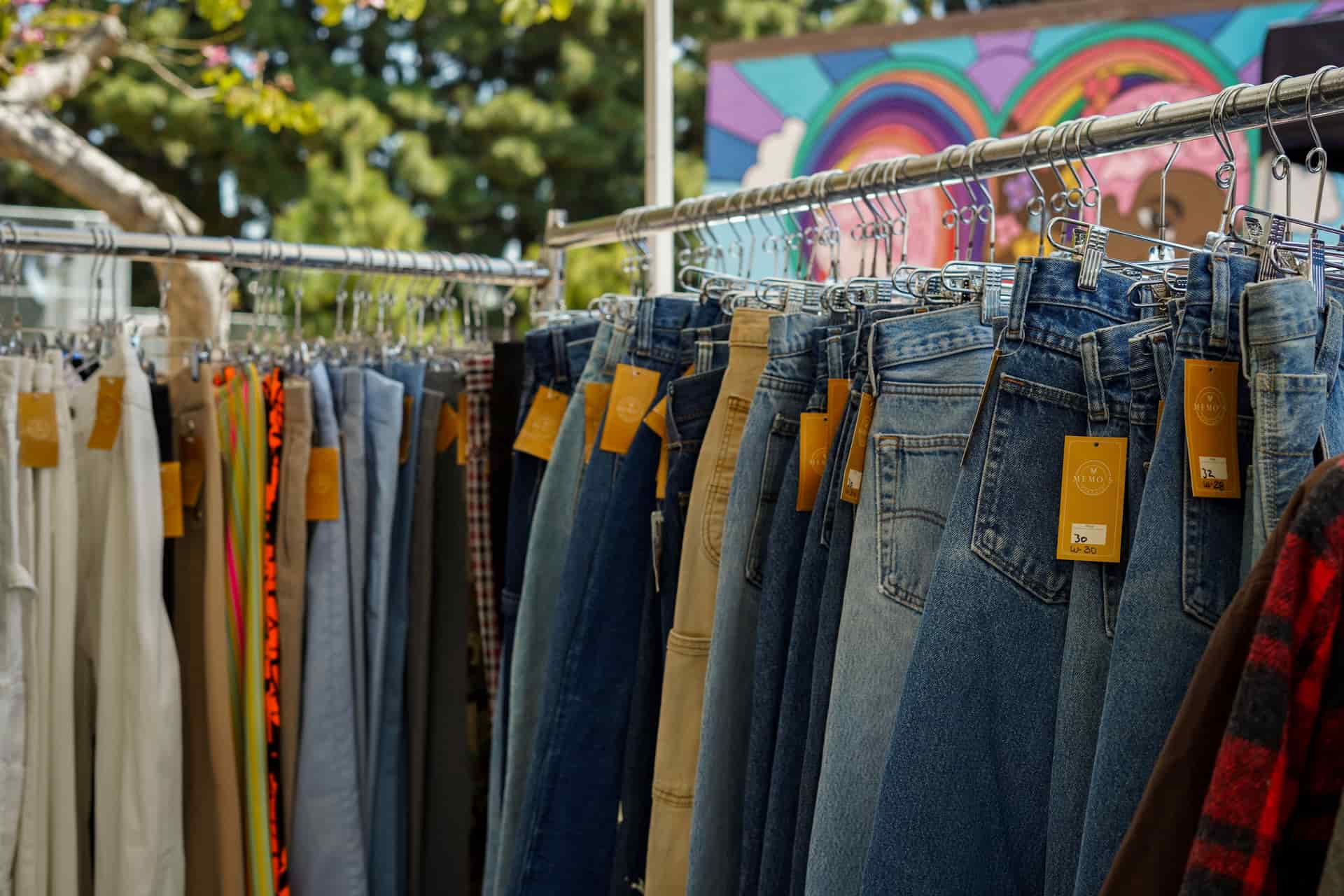 Long jeans hanging on a clothing rail.