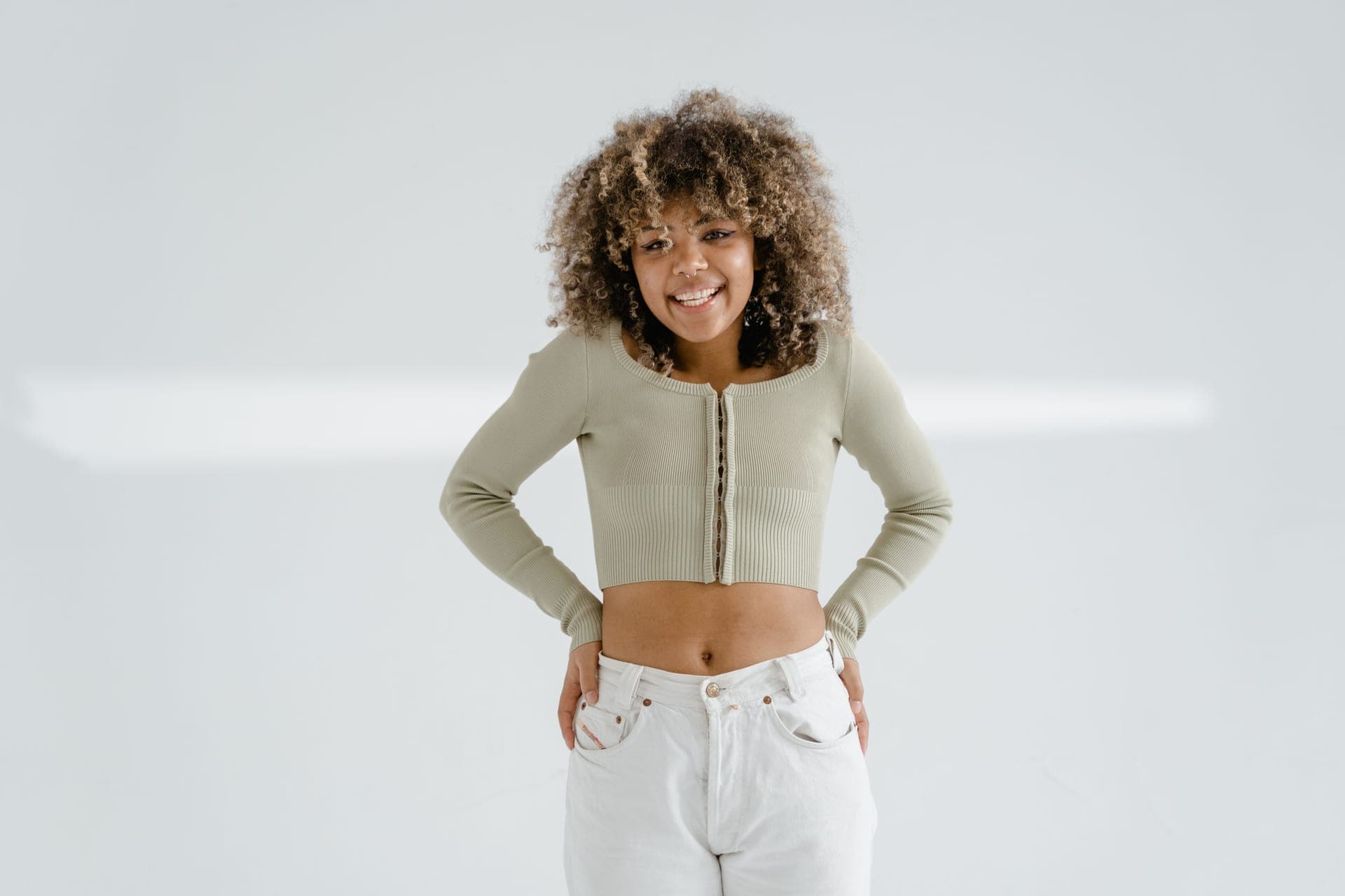 A person wearing a comfortable top against a plain background.