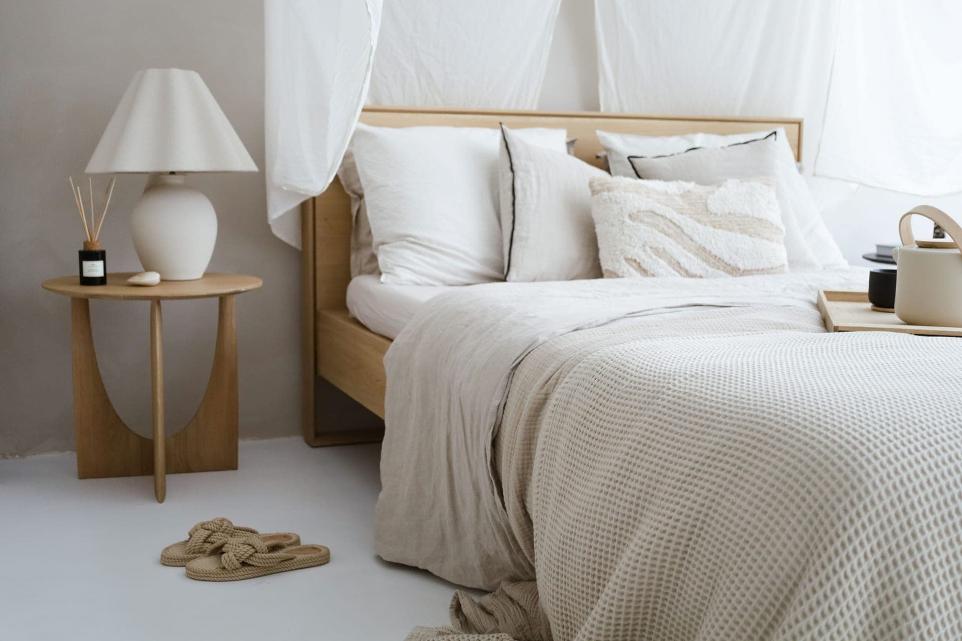 A minimalist bedroom in neutral tones.