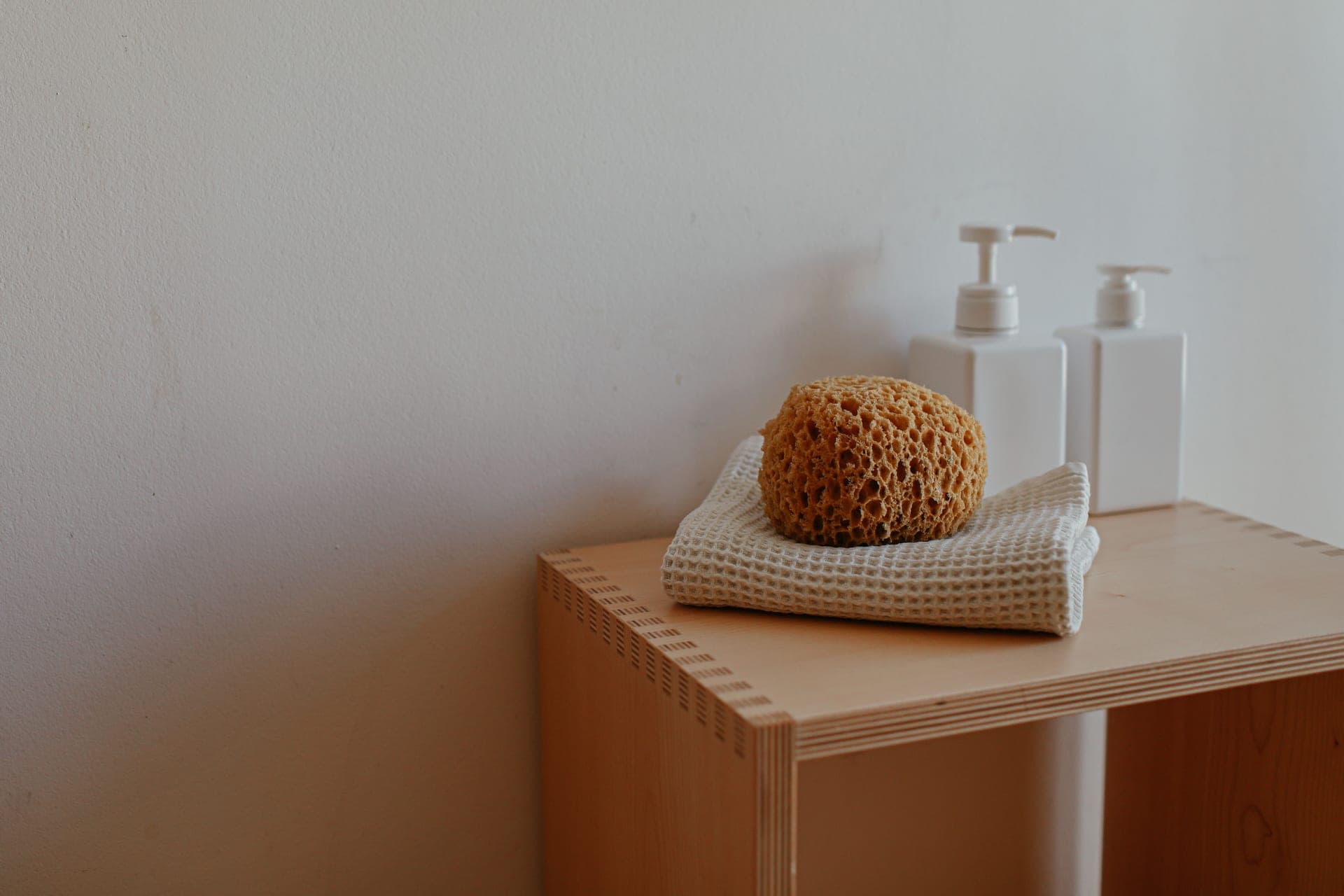 A sponge resting on a folded cloth.