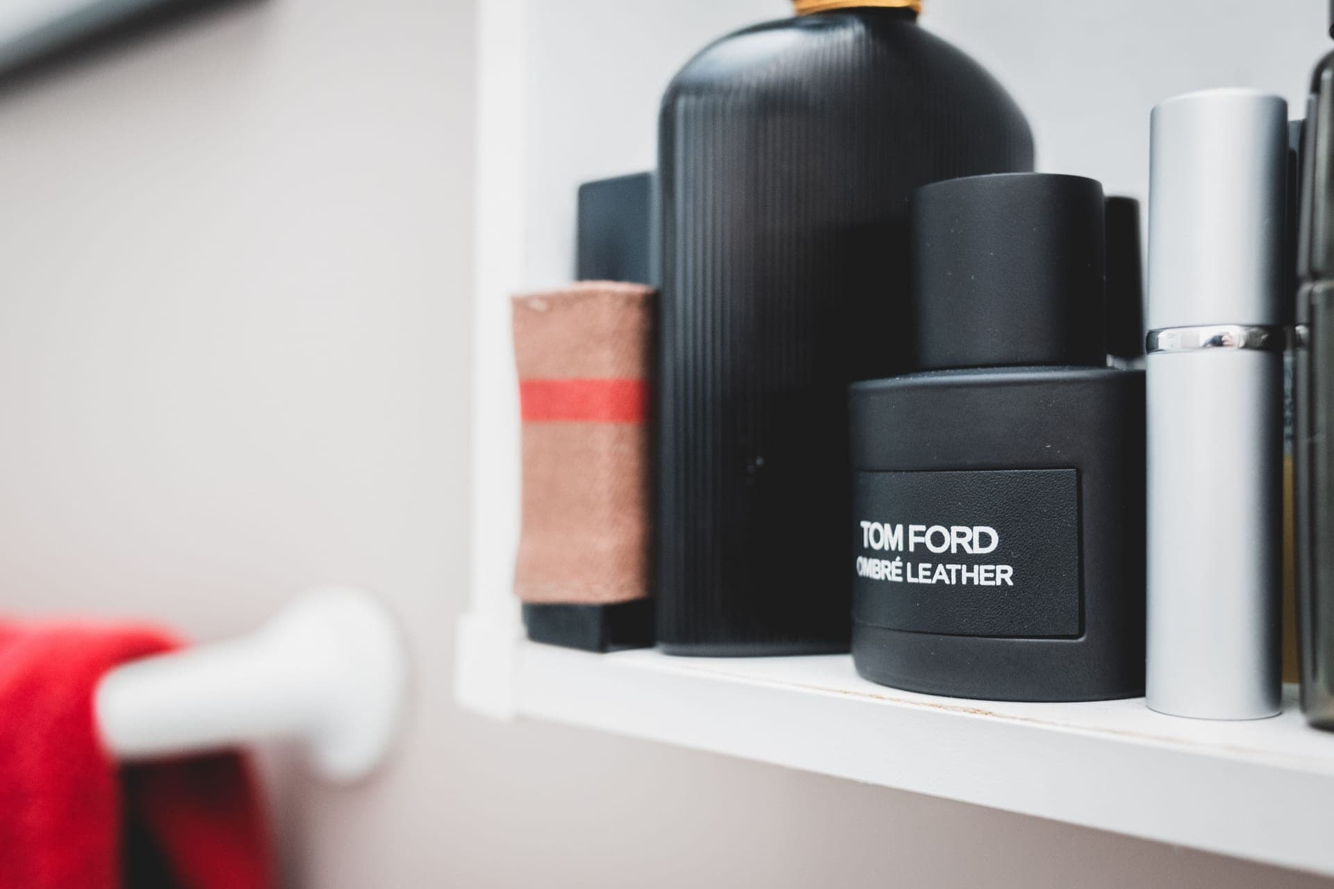 A bathroom shelf with neutral toiletries.
