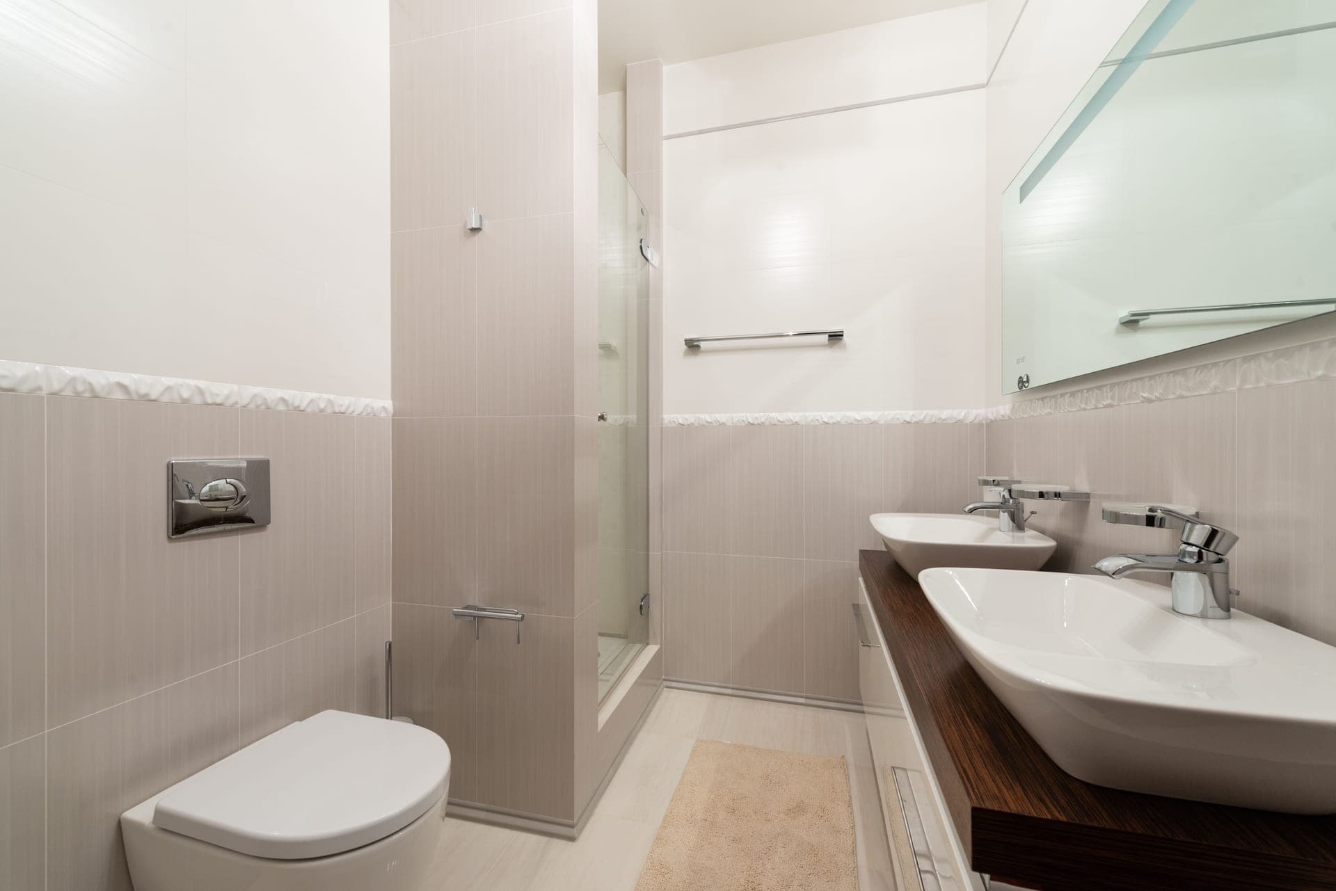 A white ceramic sink in a simple bathroom.