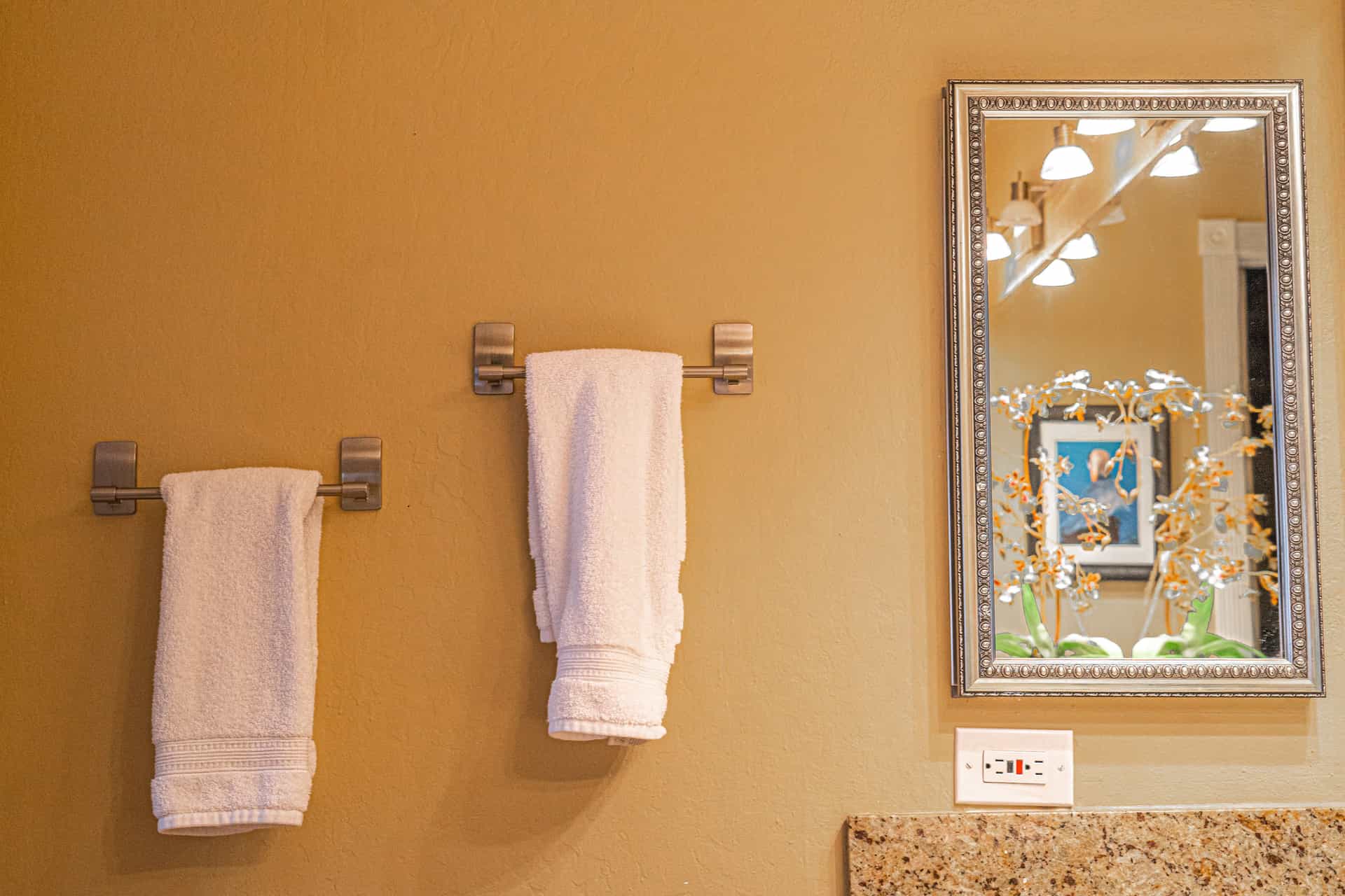 A clean neutral bathroom with folded towels.